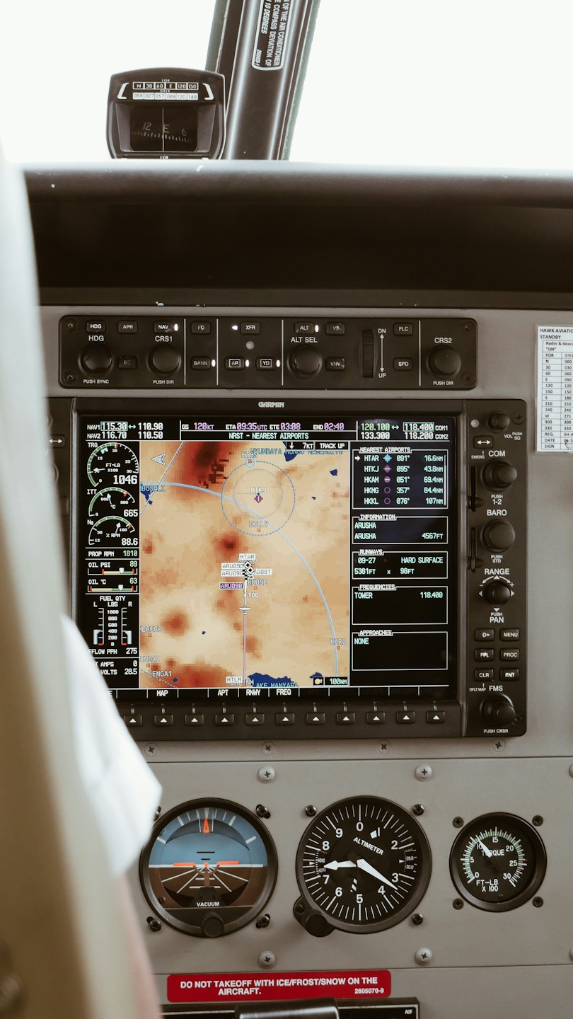 Pilot's view of aircraft cockpit instruments and navigation screen.